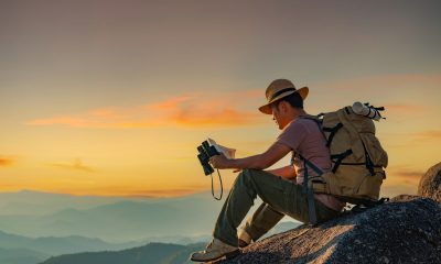 Men hike for tusks, happy to travel on the top of the mountain, sunset with a large backpack, lifestyle travel, adventure travel in the summer, outdoor travel alone in the forest.