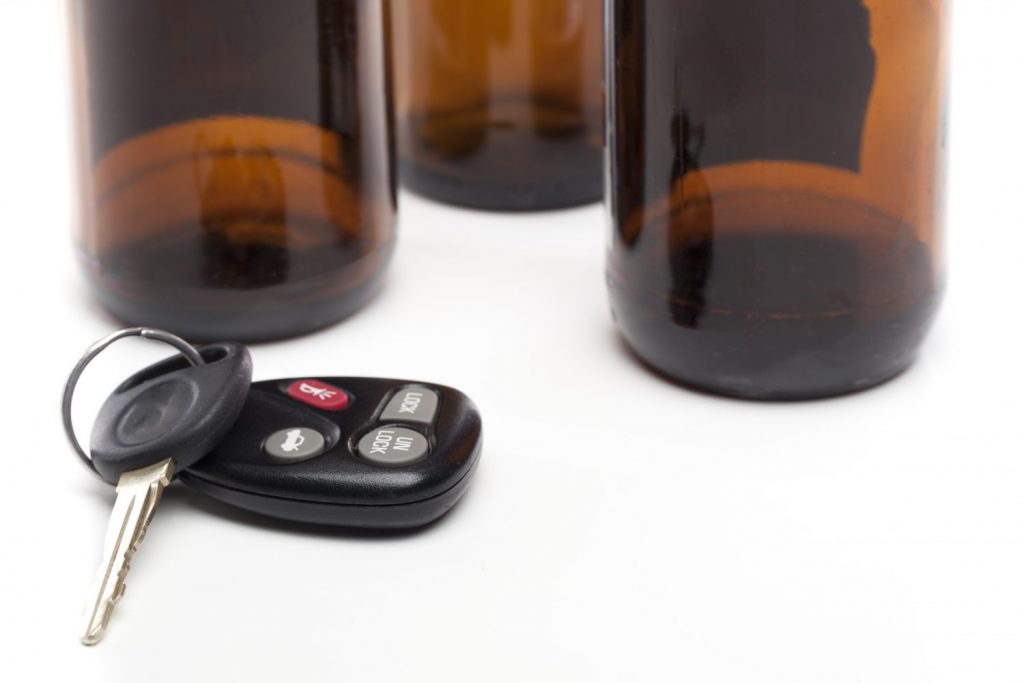 Alcohol drink and keys - drinking and driving concept