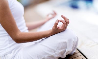 Yoga woman meditating and making a zen symbol with her hand