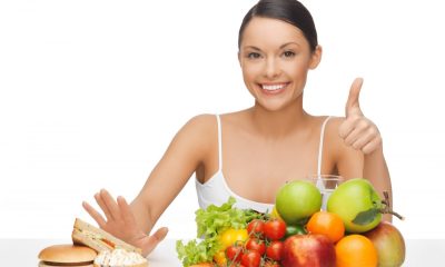 picture of woman with fruits showing thumbs up